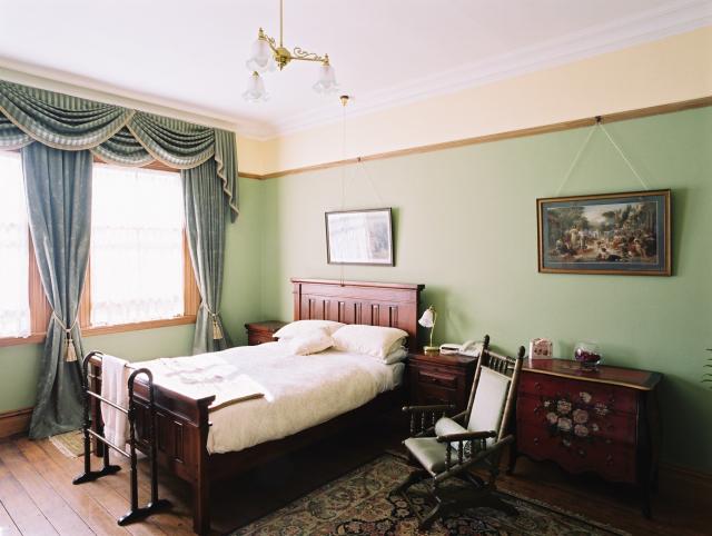 The Victorian Room at Braemar furnished in green, gold and rose tones
