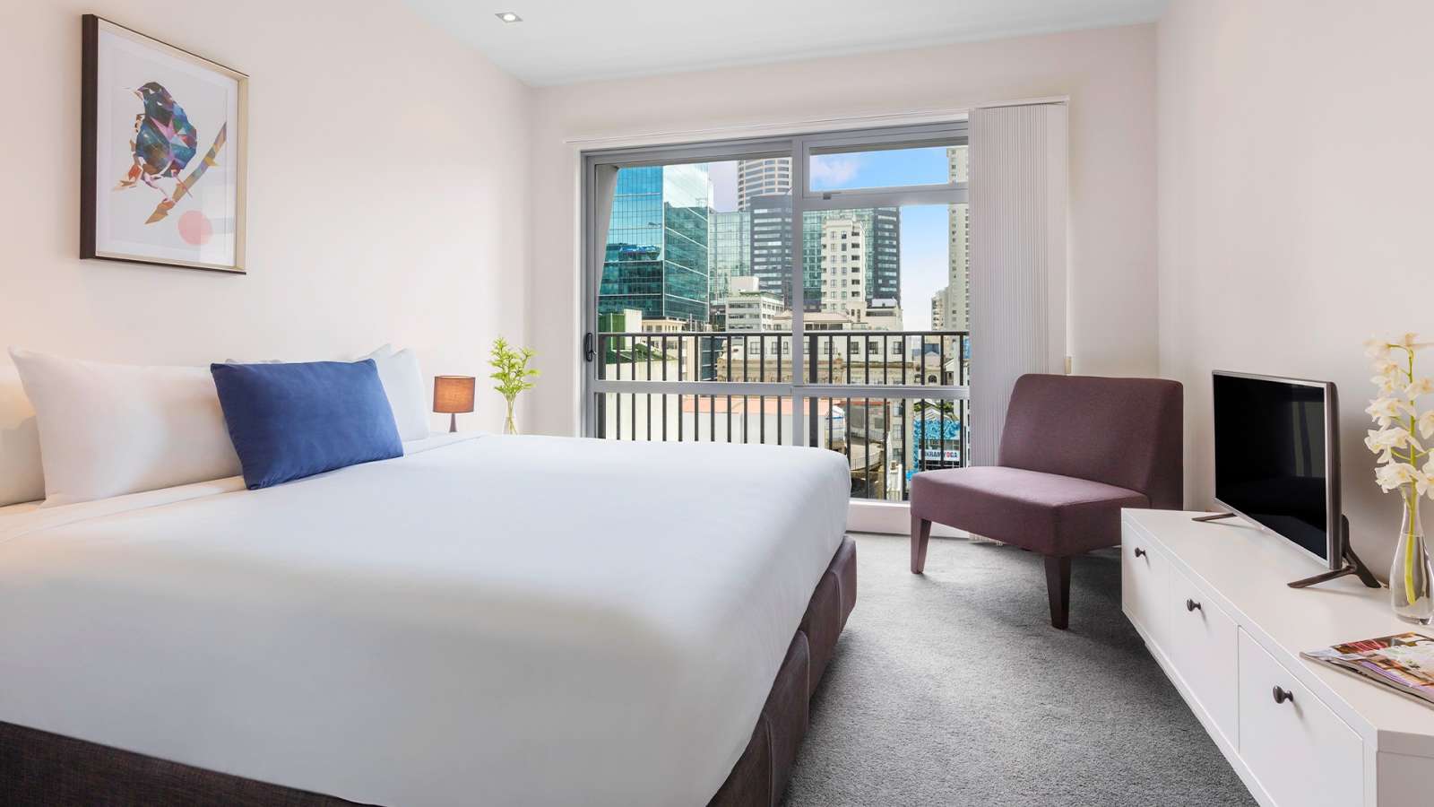 A bedroom at Auckland Harbour Suites