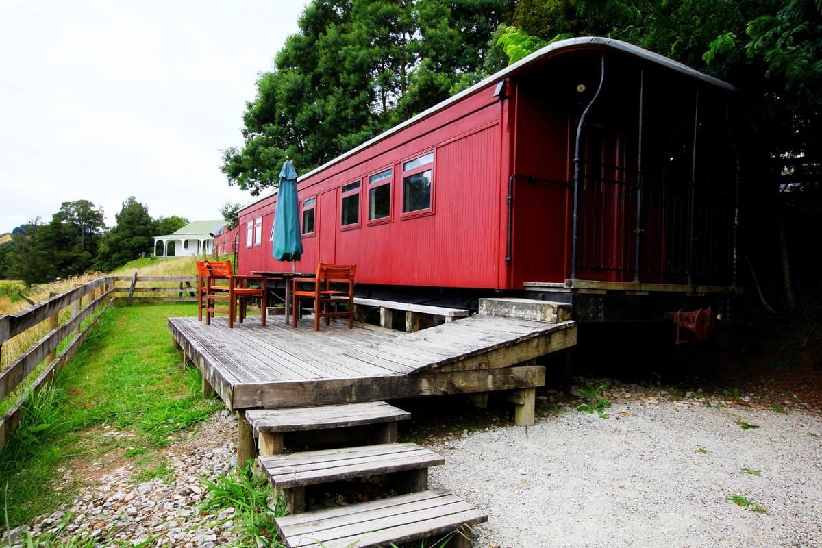 The red railway carriage motel at Woodlyn Park with an outdoor deck