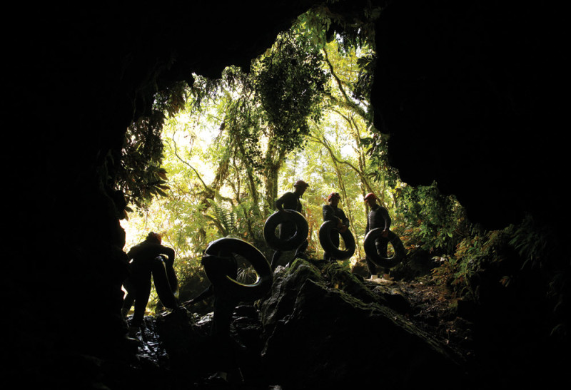 A black water rafting group beneath the glowworms in the cave
