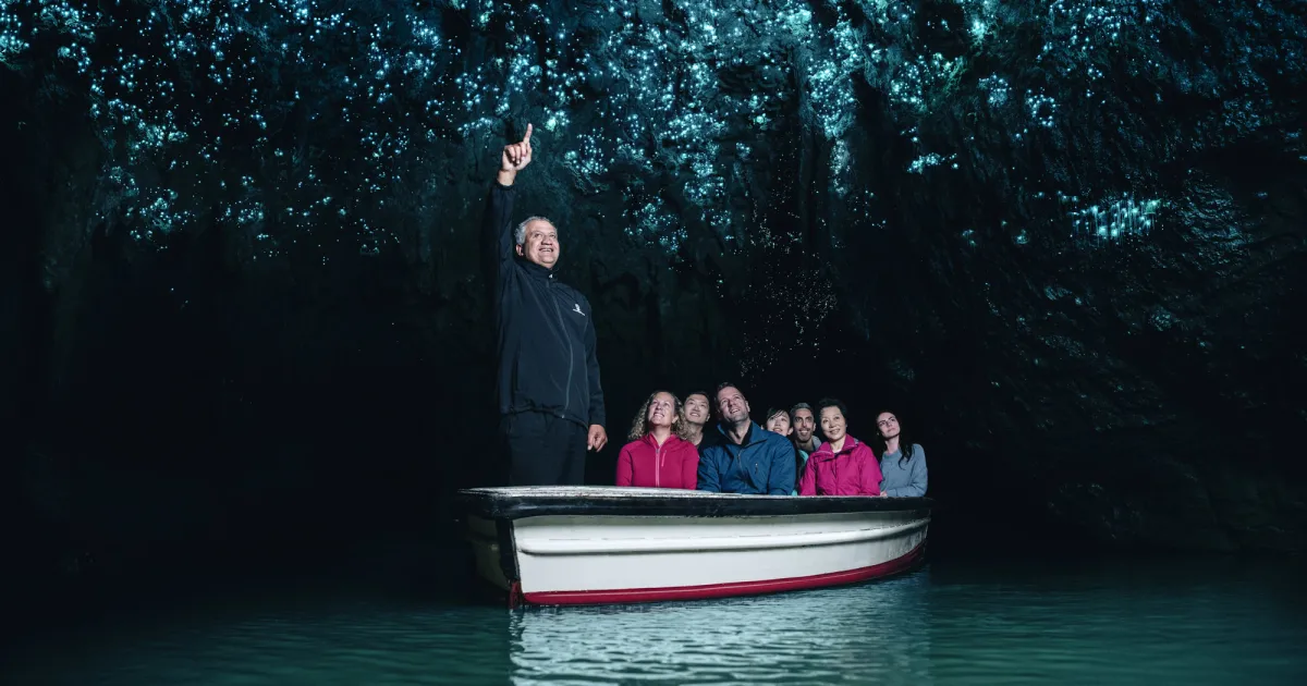 Boat gliding under the glowworm ceiling in the Waitomo Grotto